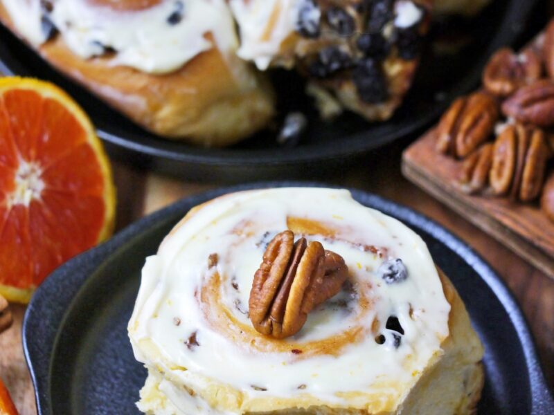 Cinnamon buns with US grown pecans, raisins and orange cream cheese frosting.